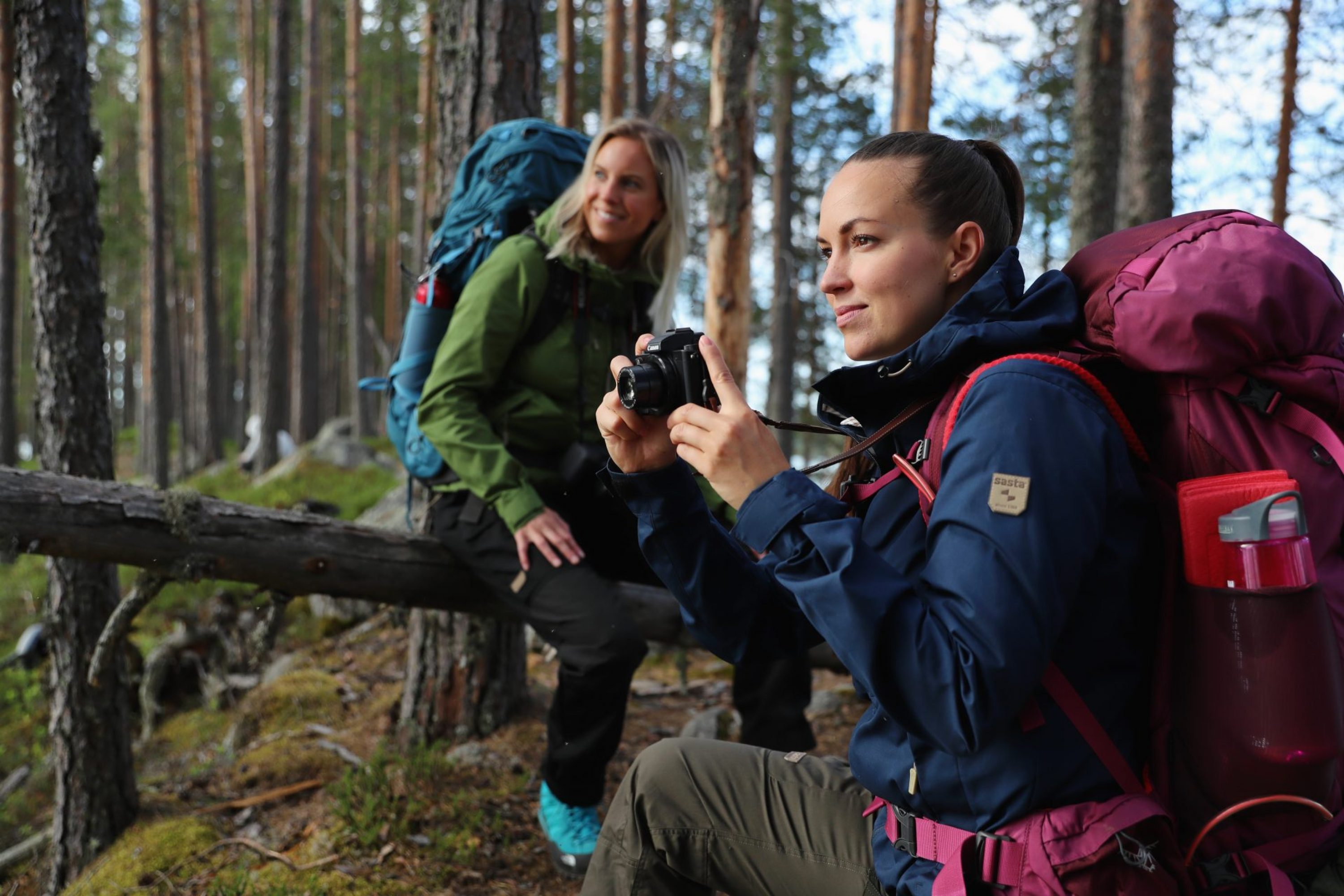 Two women photographing in forest