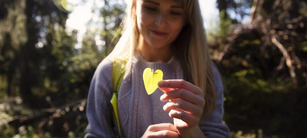A girl with a heart shaped leaf