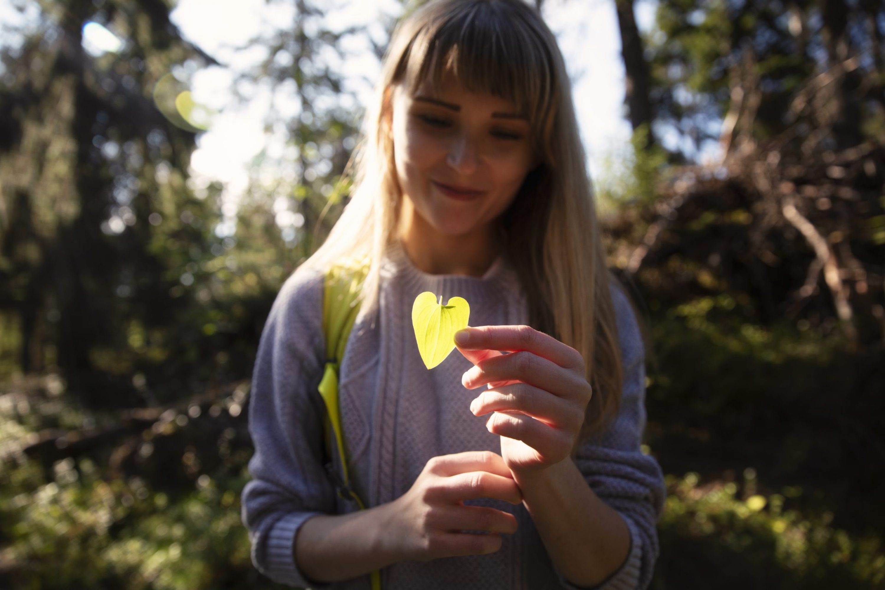 A girl with a heart shaped leaf